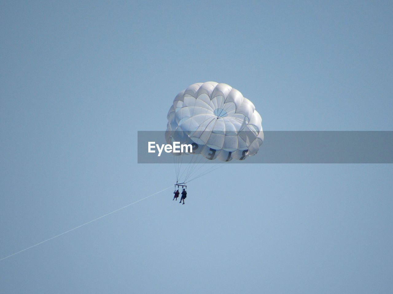 LOW ANGLE VIEW OF PARAGLIDING AGAINST SKY