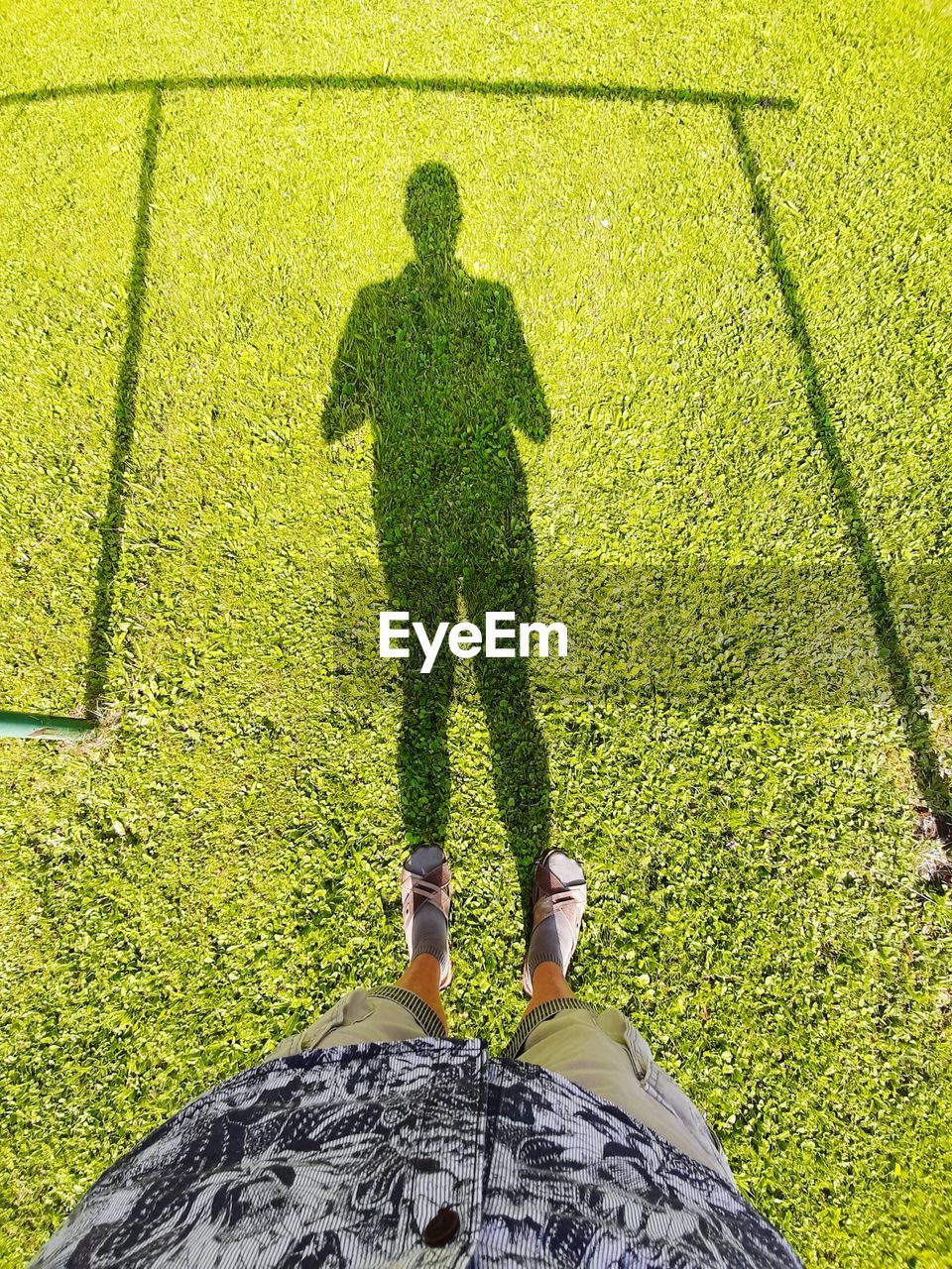 Low section of man standing on paving stone