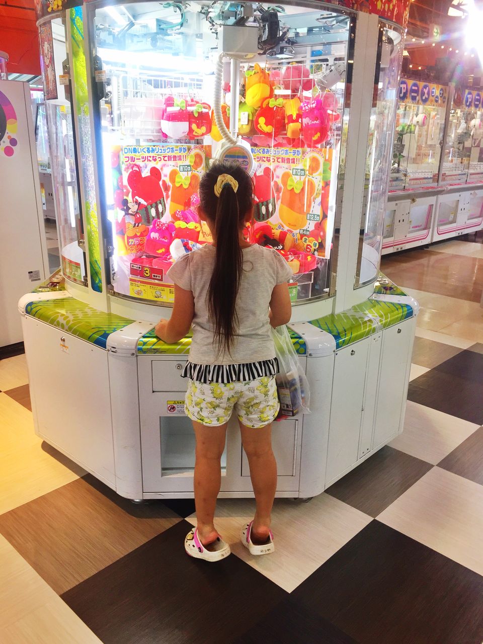 FULL LENGTH REAR VIEW OF WOMAN STANDING AGAINST STORE