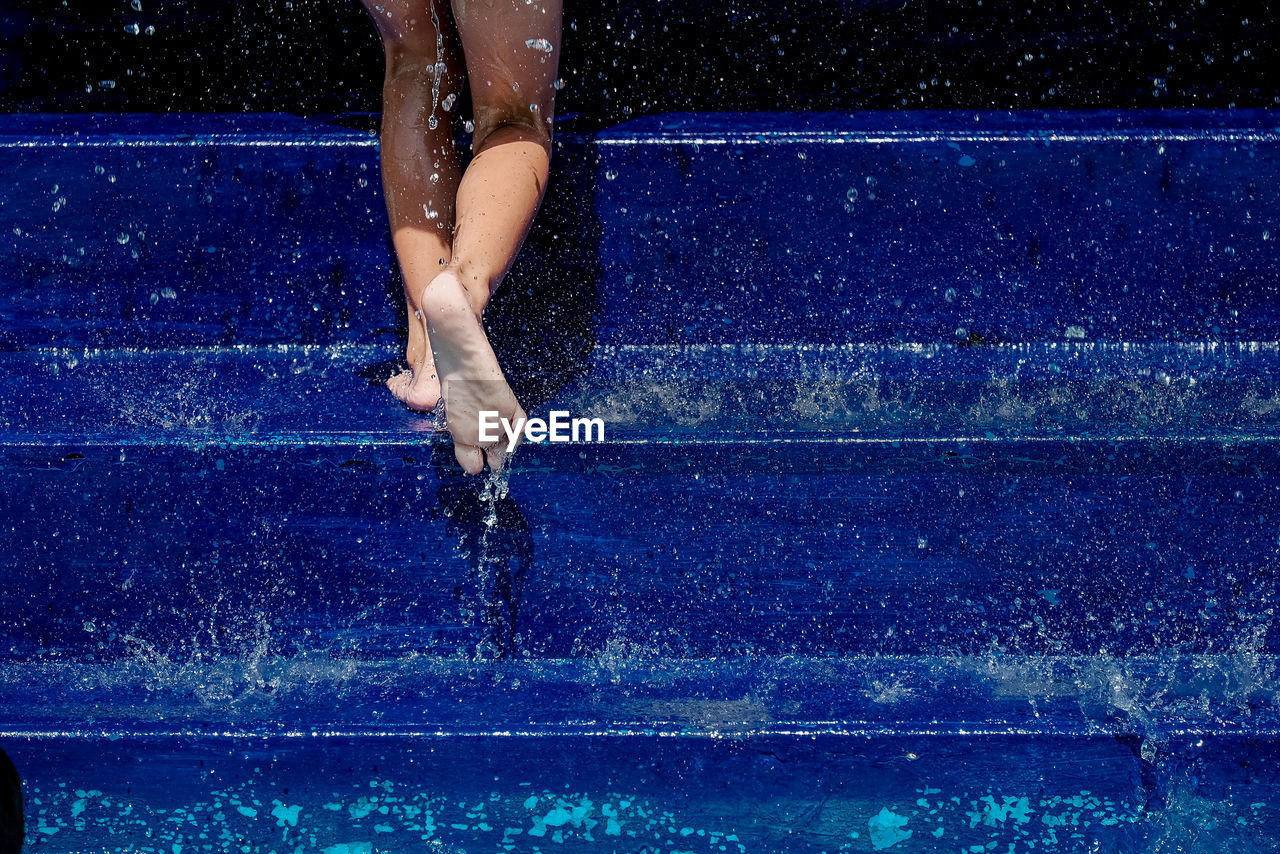 Woman walking on steps in pool