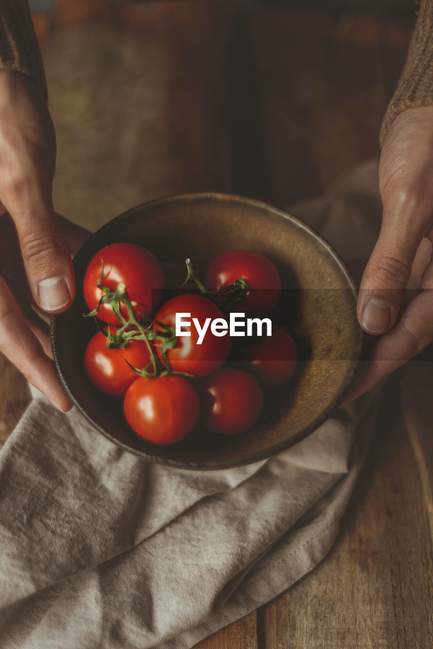 MIDSECTION OF PERSON HOLDING FRUIT