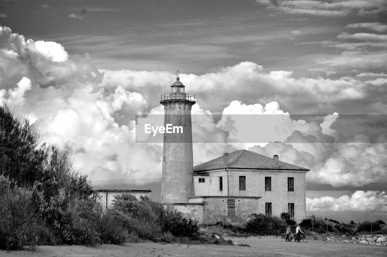 Lighthouse against cloudy sky