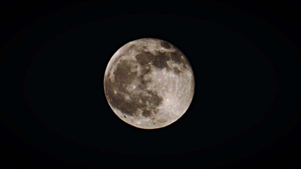 LOW ANGLE VIEW OF MOON IN SKY AT NIGHT