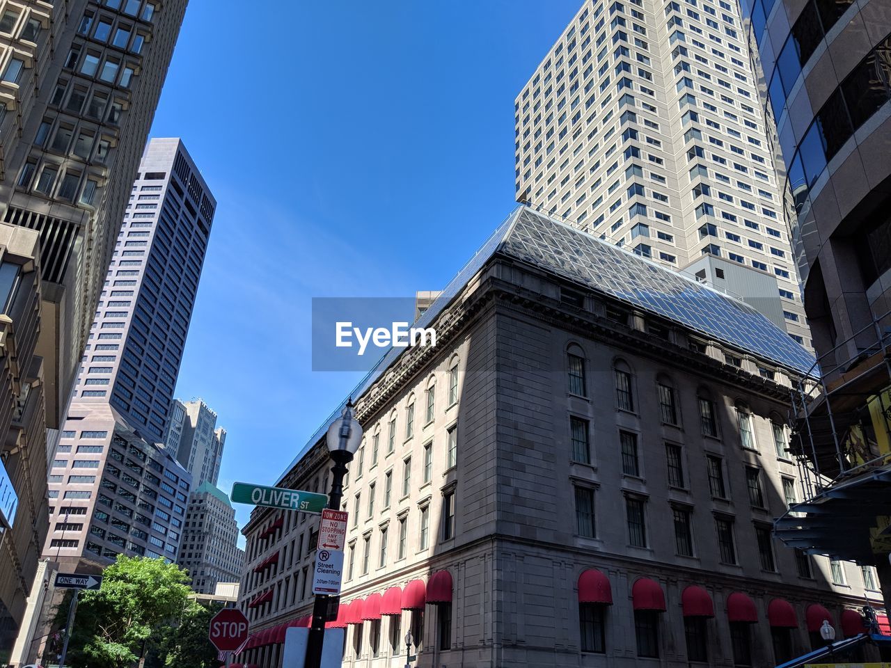 LOW ANGLE VIEW OF BUILDINGS AGAINST CLEAR BLUE SKY