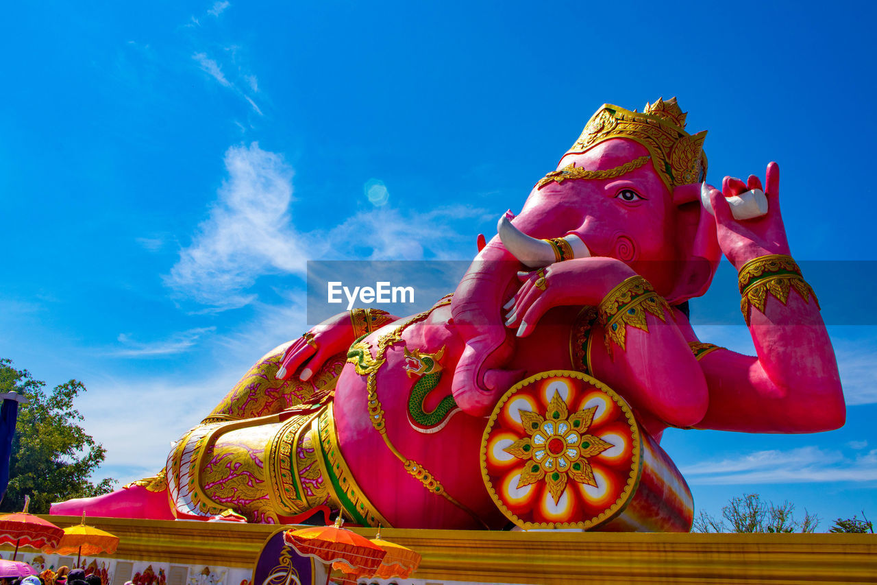 Low angle view of ganesha statue against sky