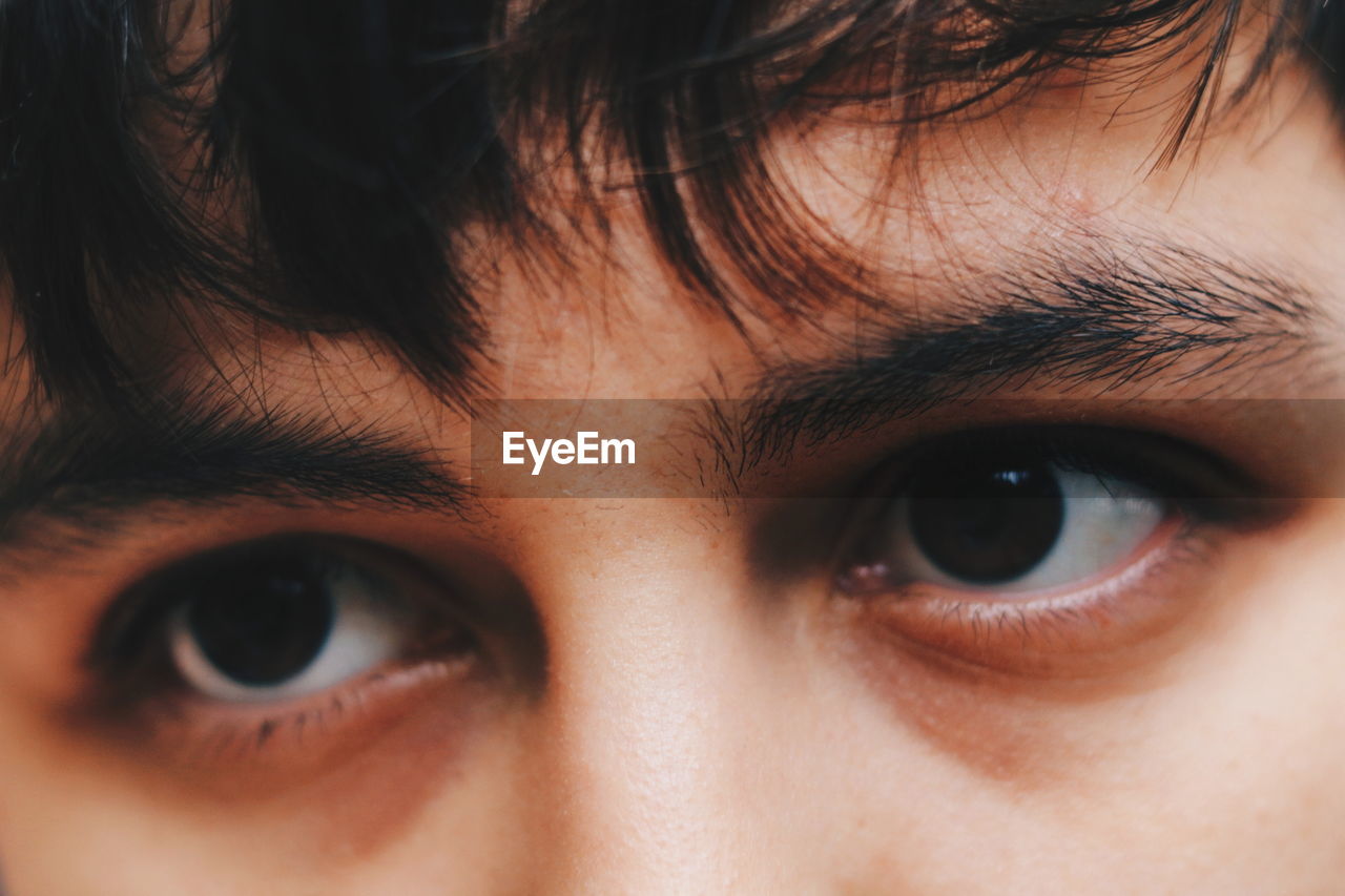 CLOSE-UP PORTRAIT OF BOY WITH BLUE EYES