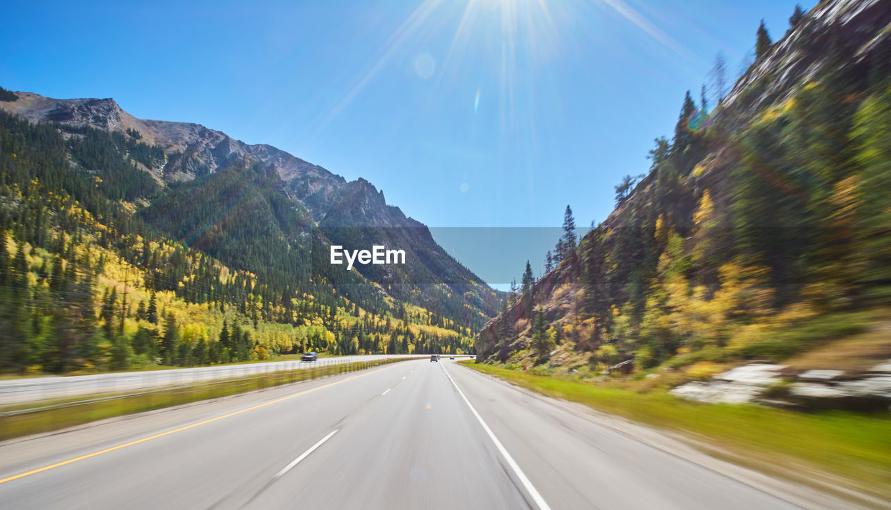 PANORAMIC VIEW OF MOUNTAIN ROAD AGAINST SKY