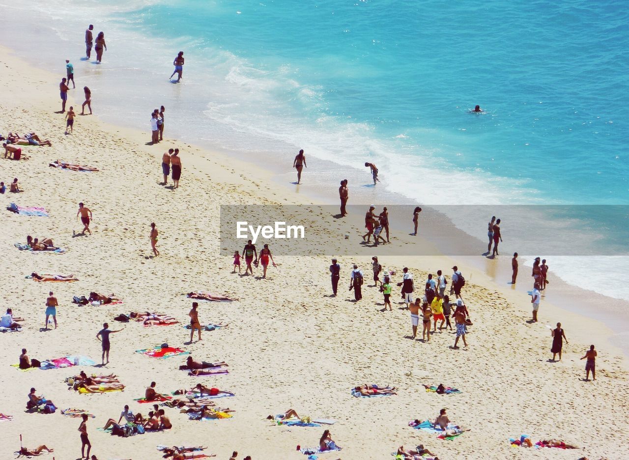 High angle view of people at beach during sunny day
