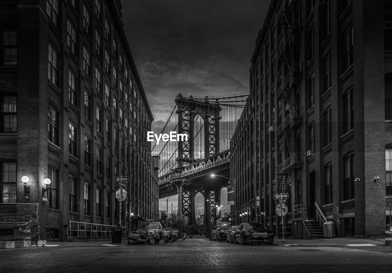 Street amidst buildings in city at night