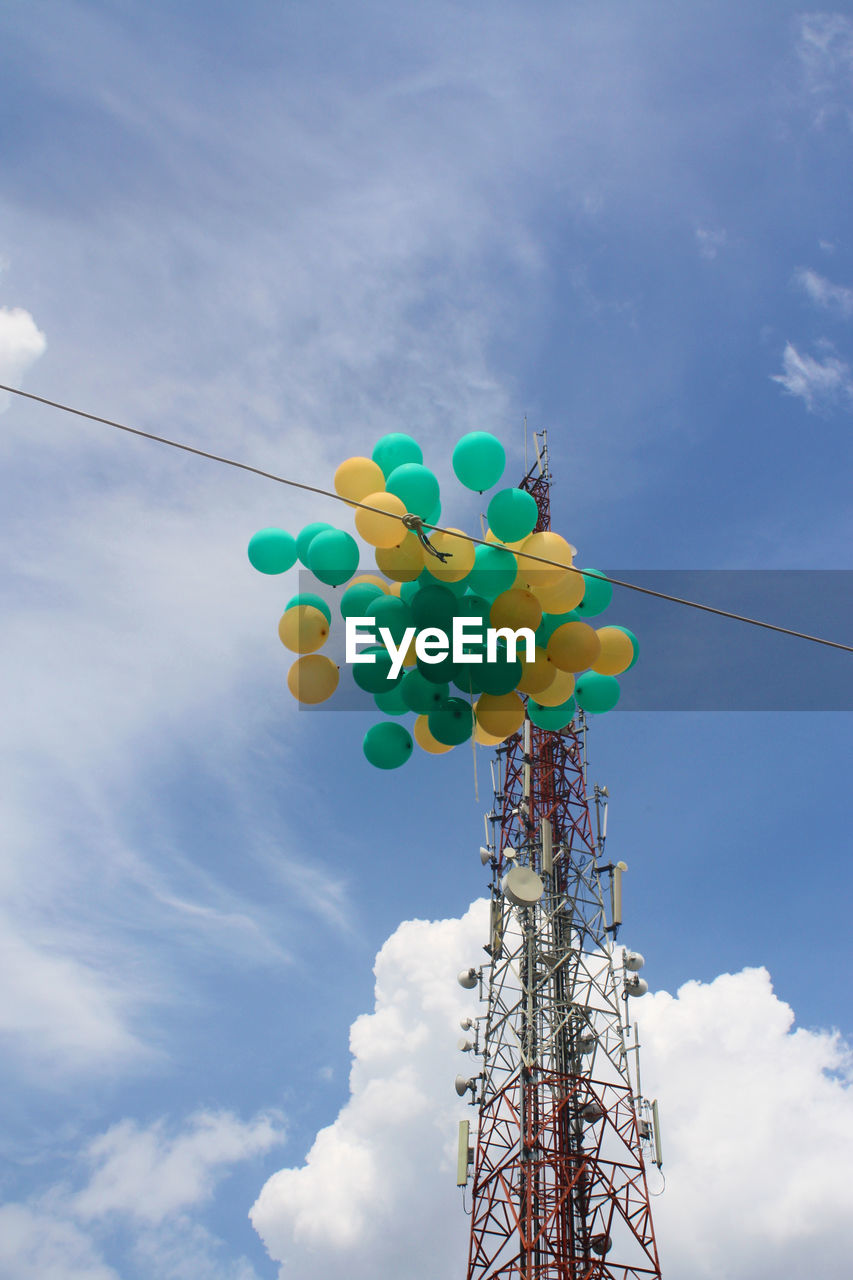 LOW ANGLE VIEW OF MULTI COLORED BALLOONS AGAINST BLUE SKY