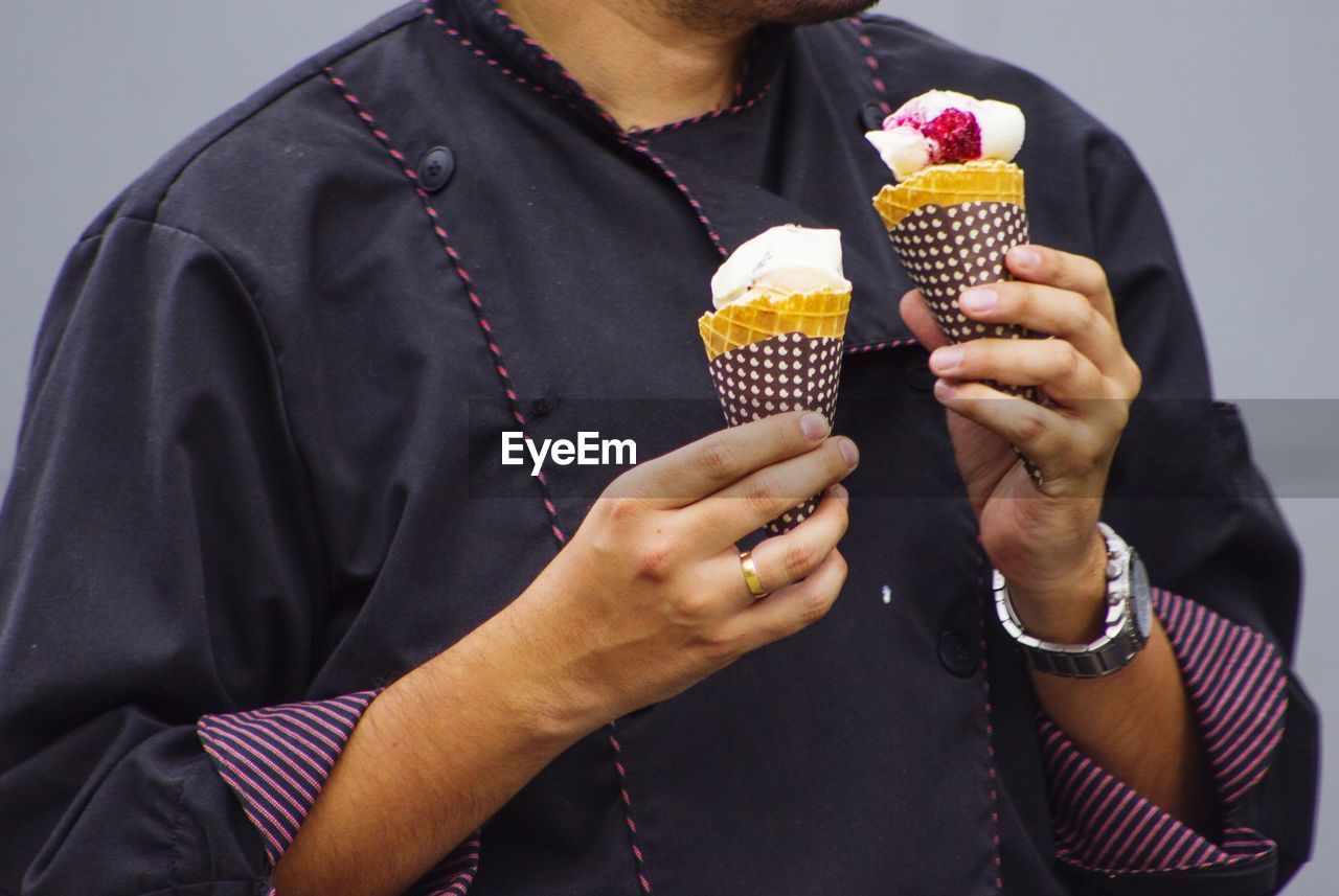 Midsection of man holding ice cream