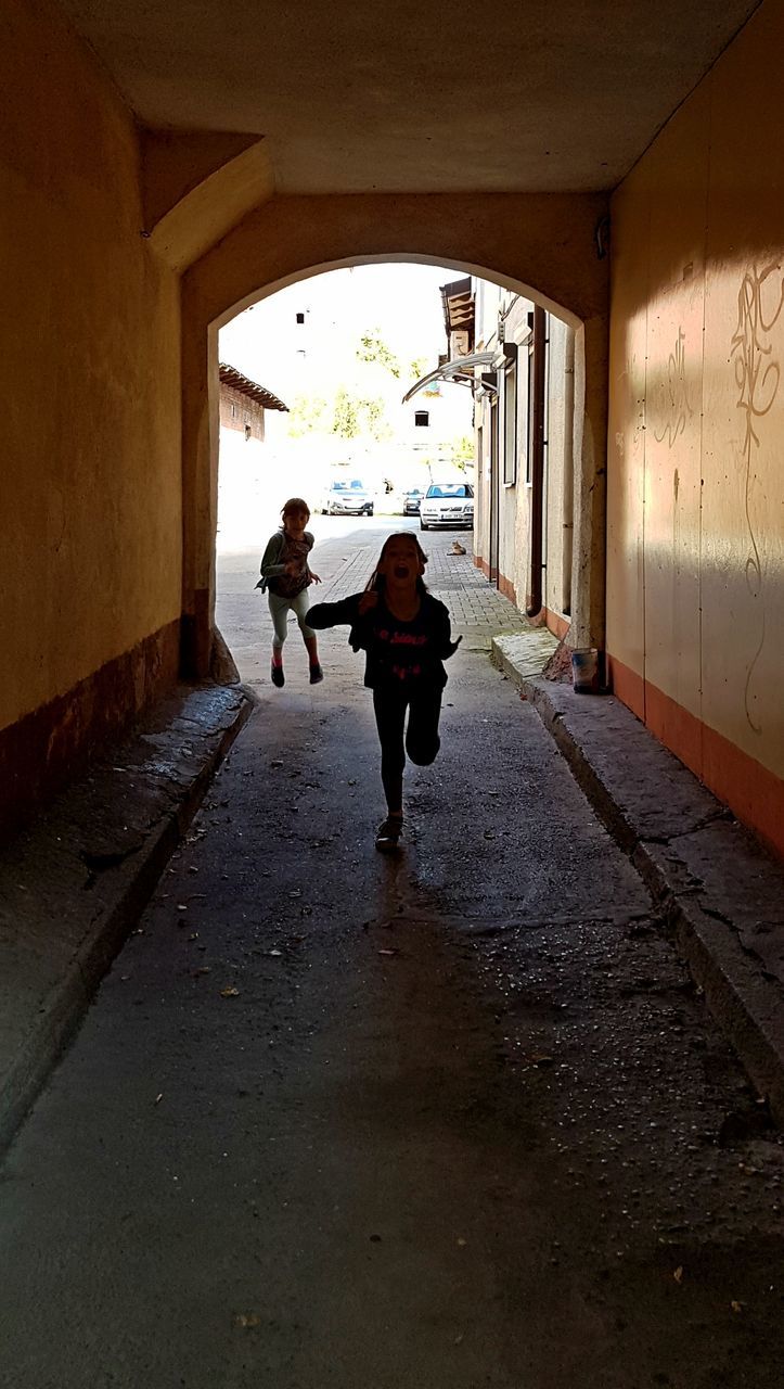 Happy girls running in tunnel