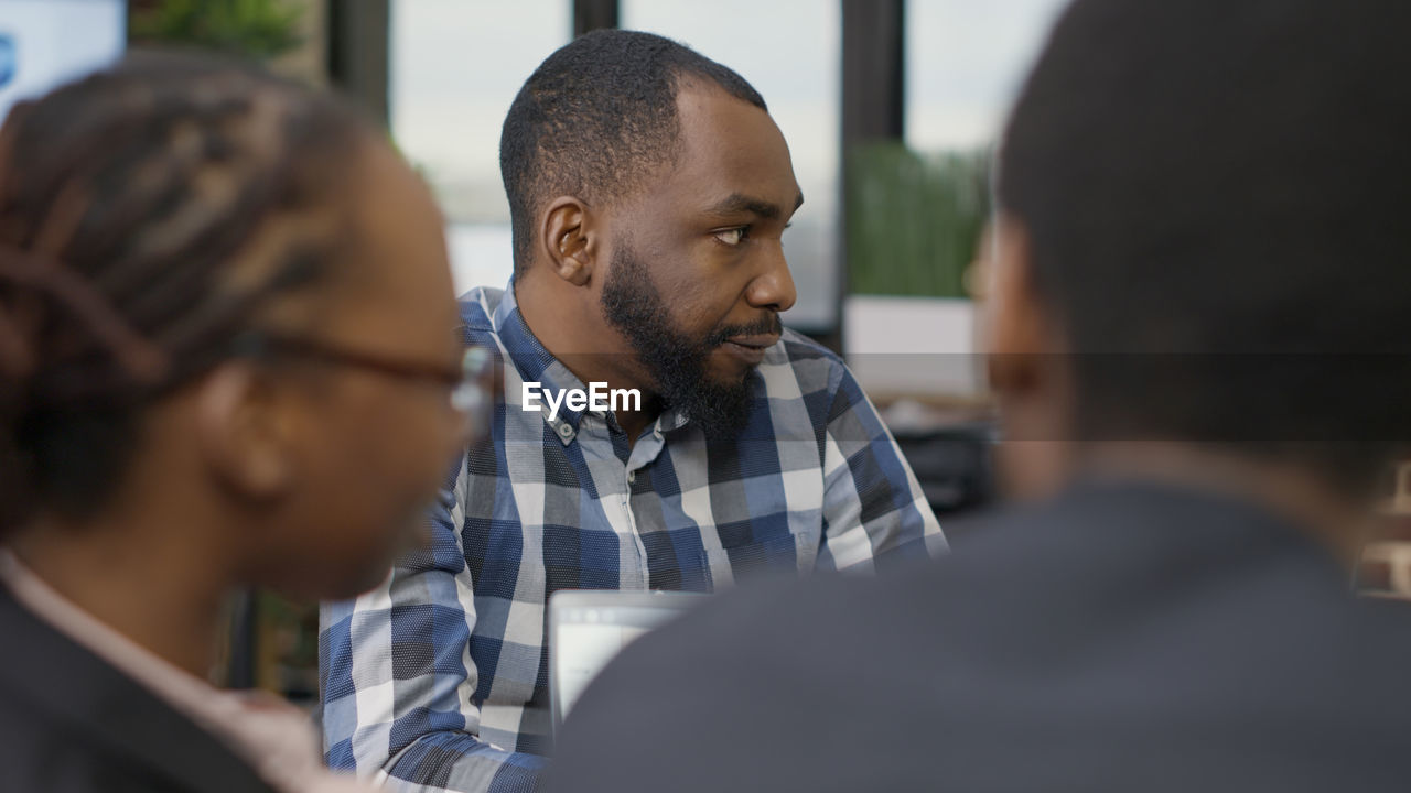 Side view of young businessman looking away