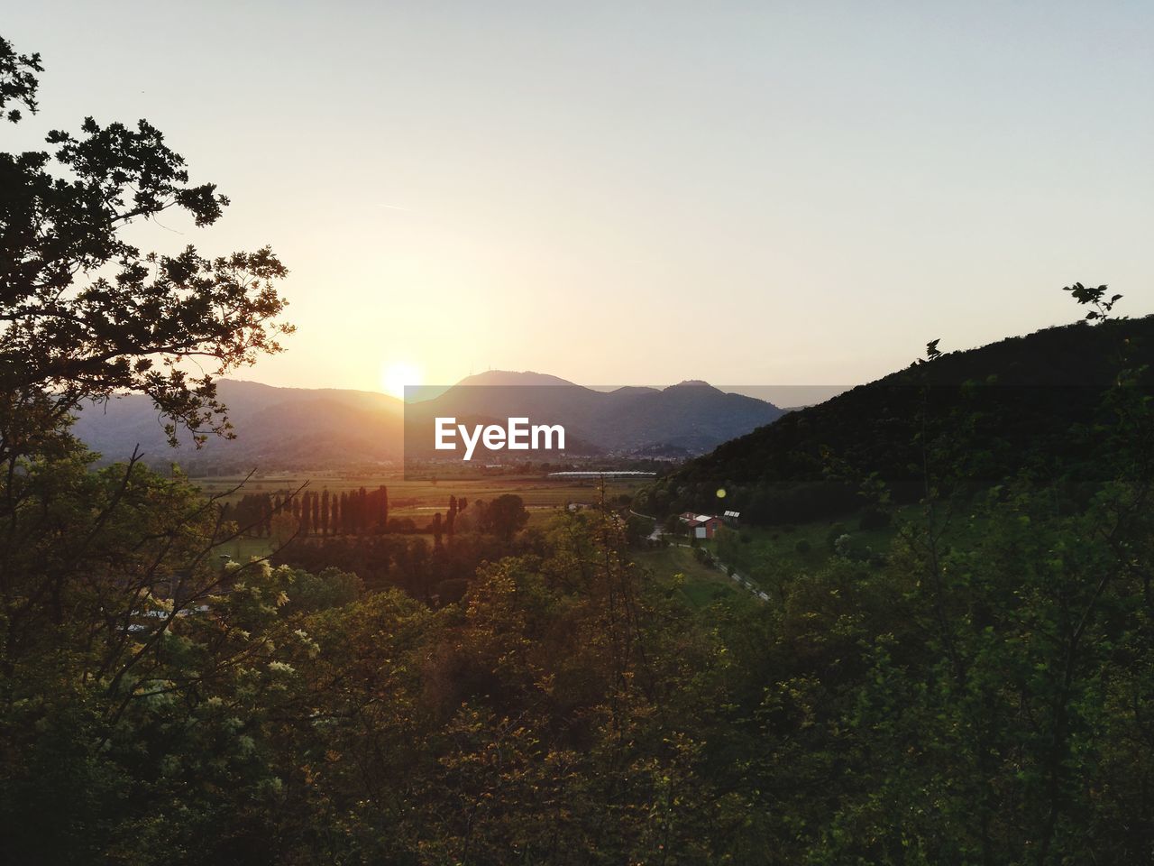 SCENIC VIEW OF MOUNTAINS AGAINST CLEAR SKY DURING SUNSET