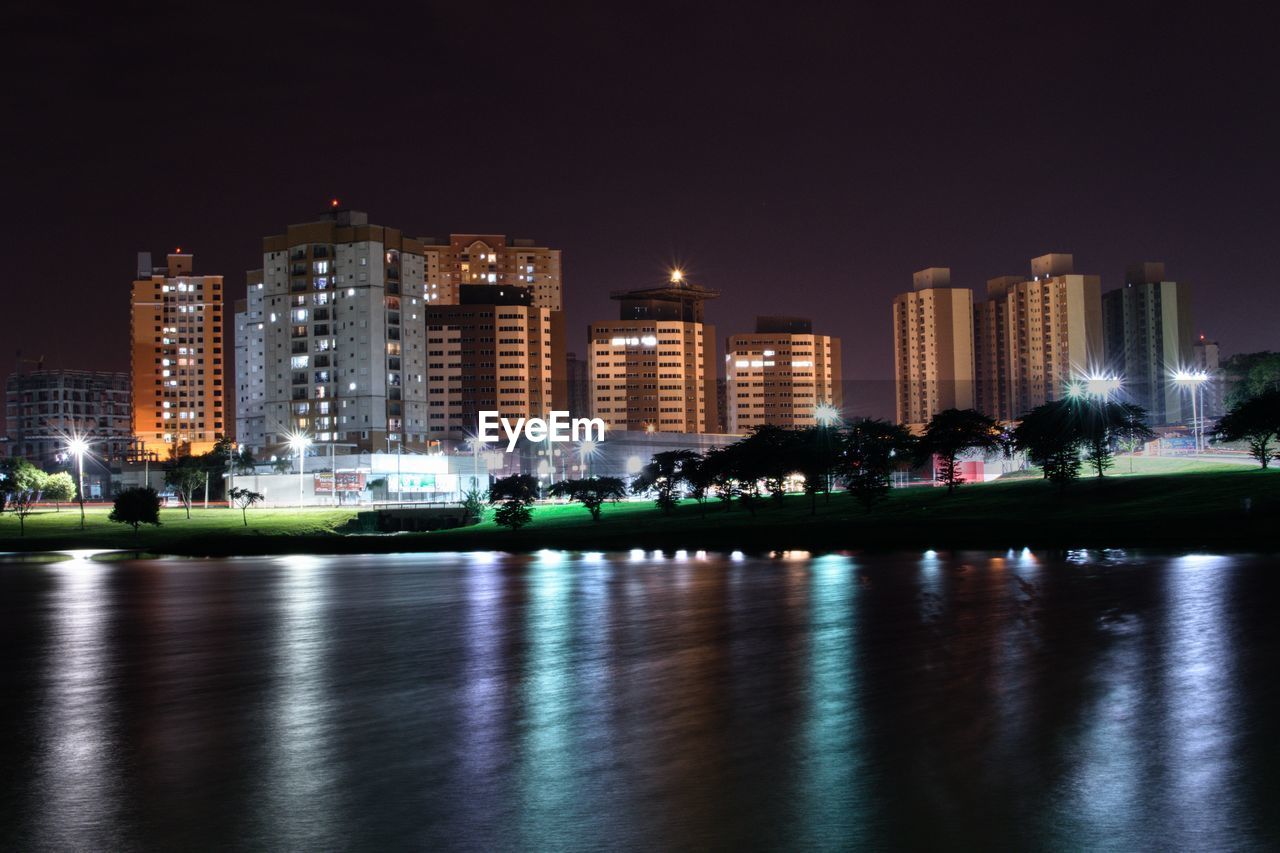 ILLUMINATED BUILDINGS AT WATERFRONT