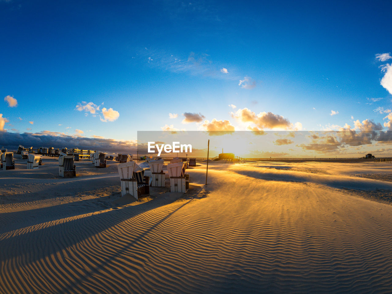 Scenic view of beach against sky during sunset