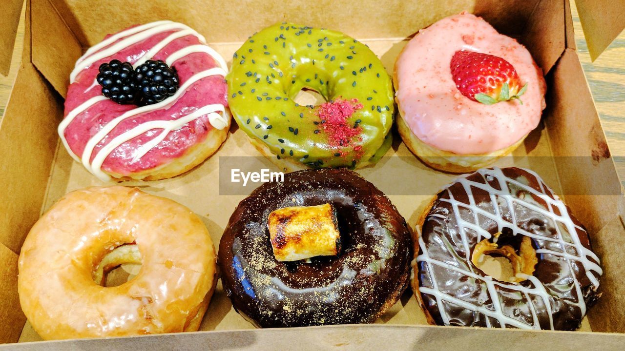High angle view of various donuts in box