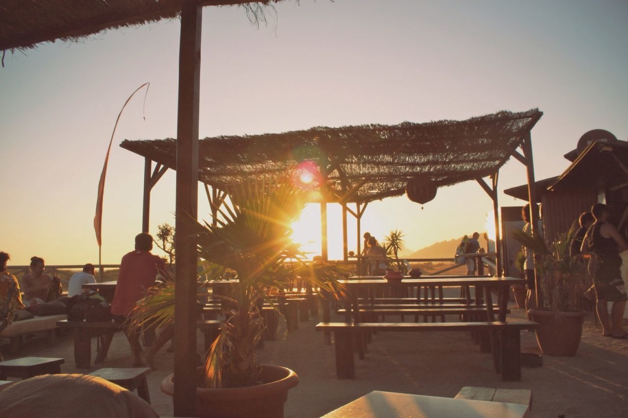 Group of people at outdoor restaurant at sunset