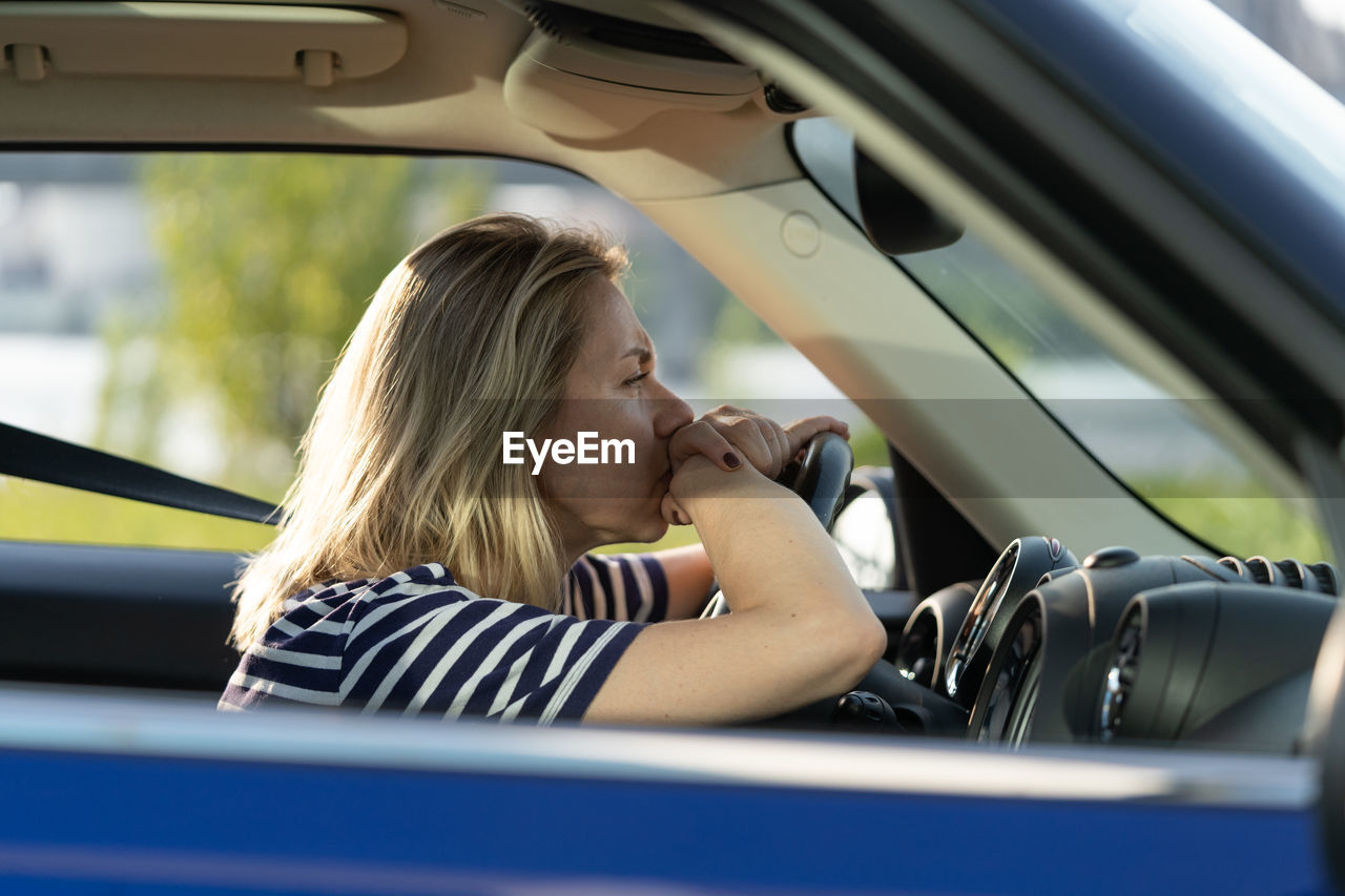 Portrait of woman sitting in car