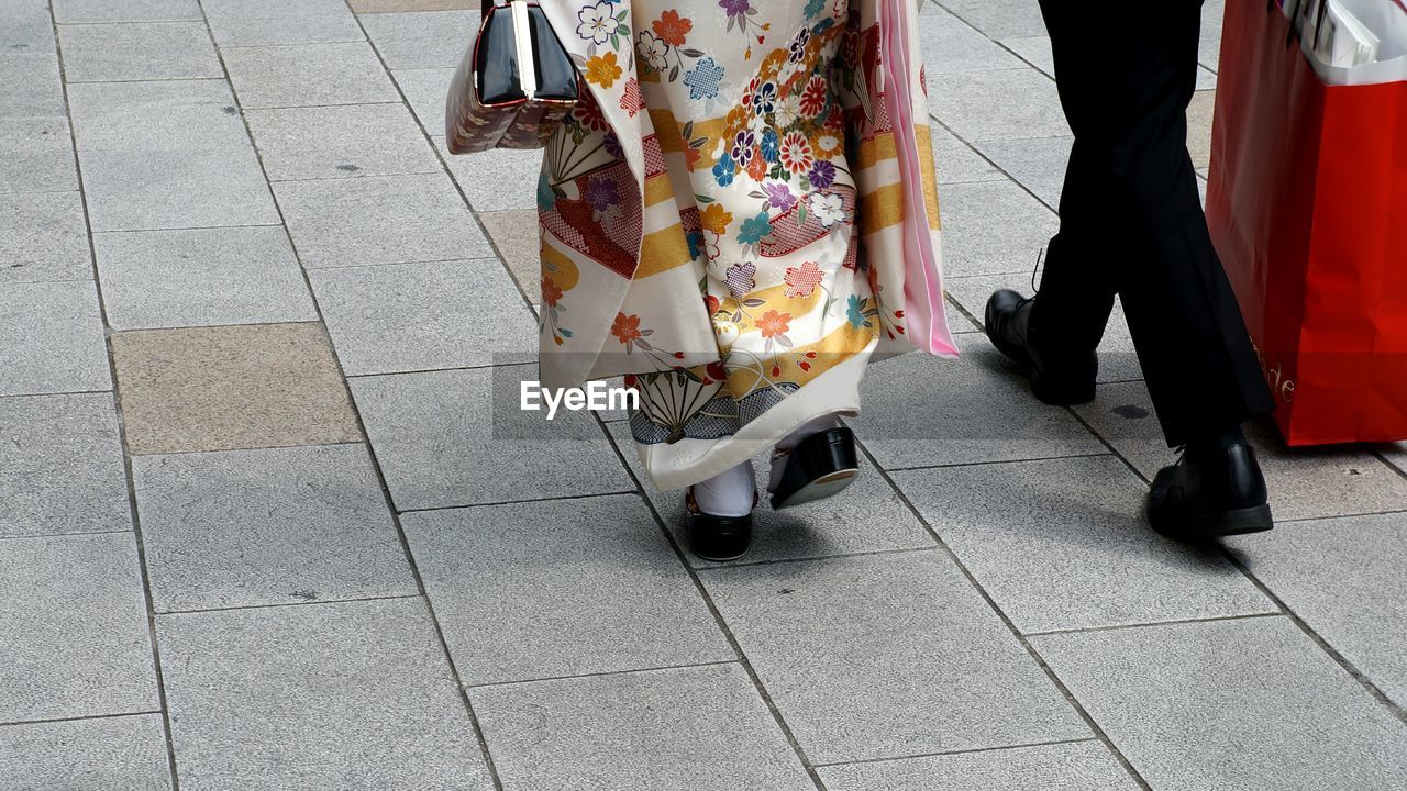 Rear view of people walking on street