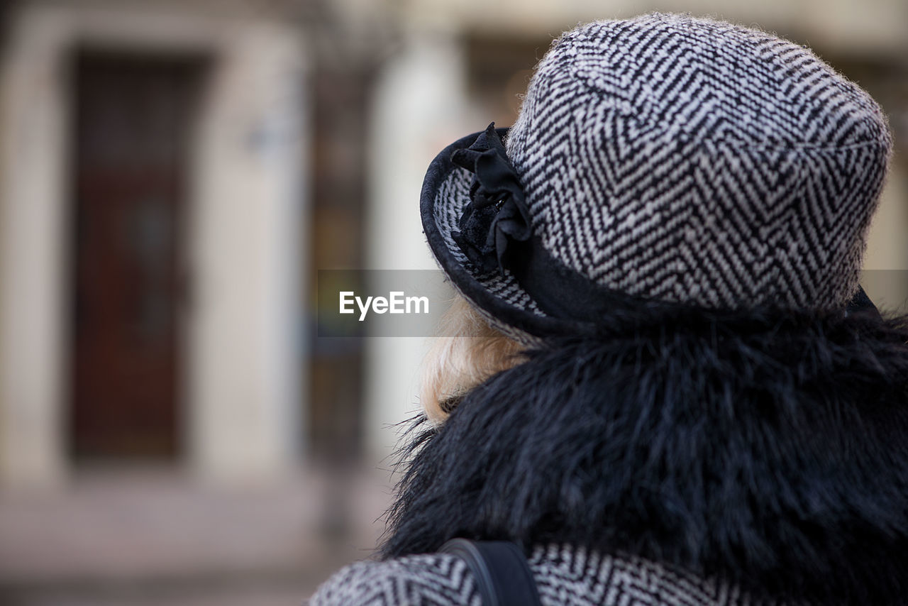 Rear view of woman wearing hat in city