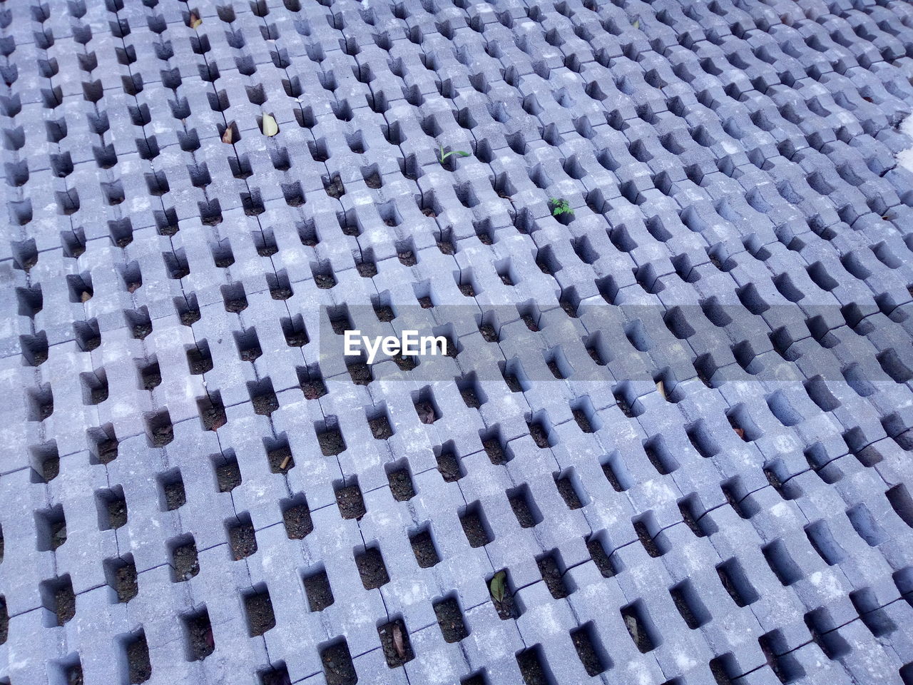 FULL FRAME SHOT OF METAL GRATE AGAINST BRICK WALL