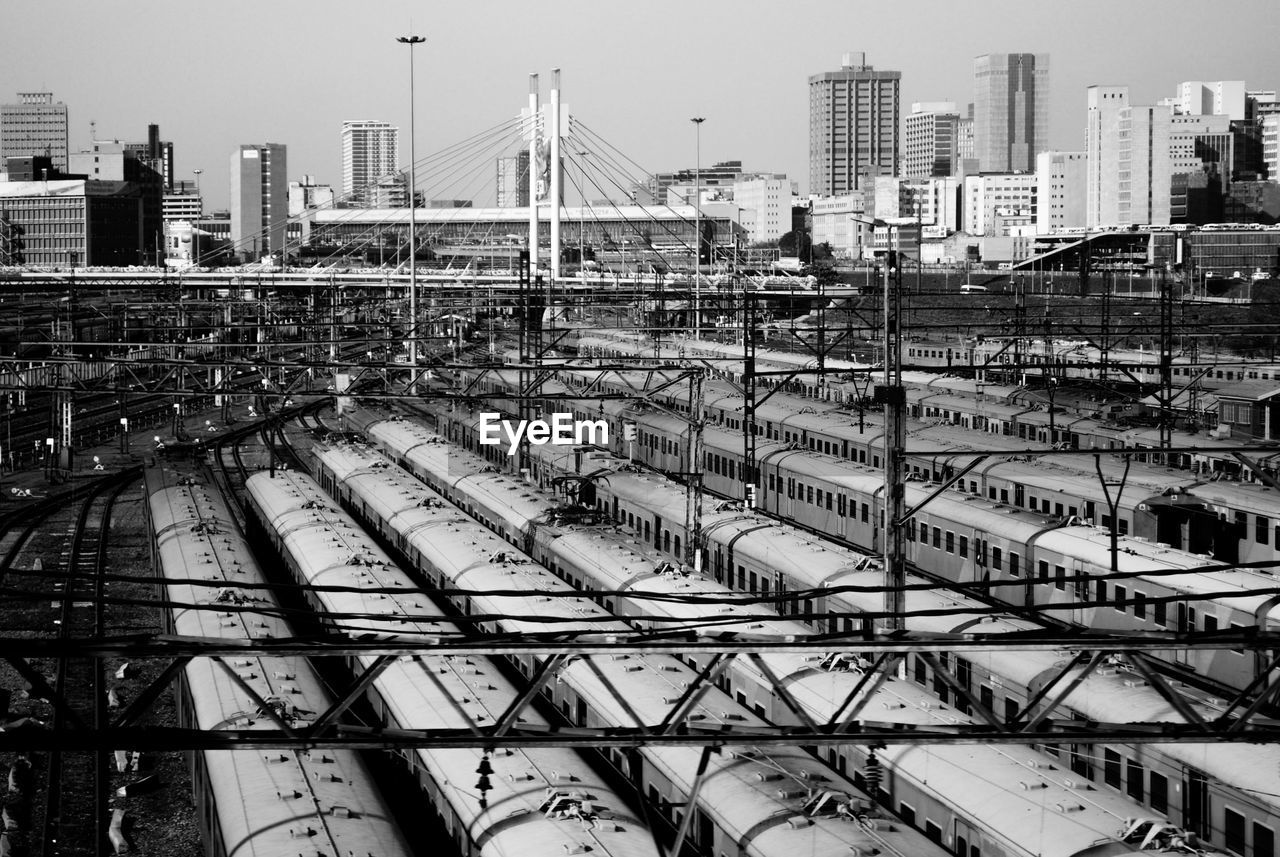 Railroad tracks in city against sky