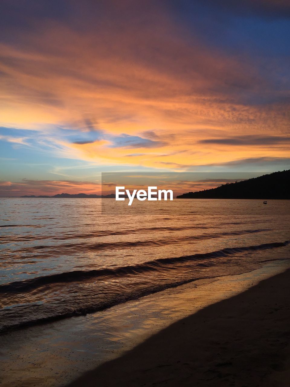 Scenic view of beach against sky during sunset