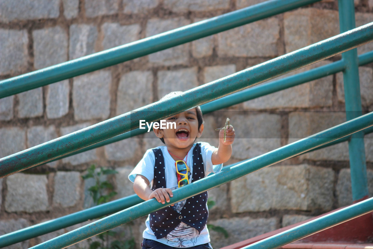 Portrait of smiling boy standing on steps