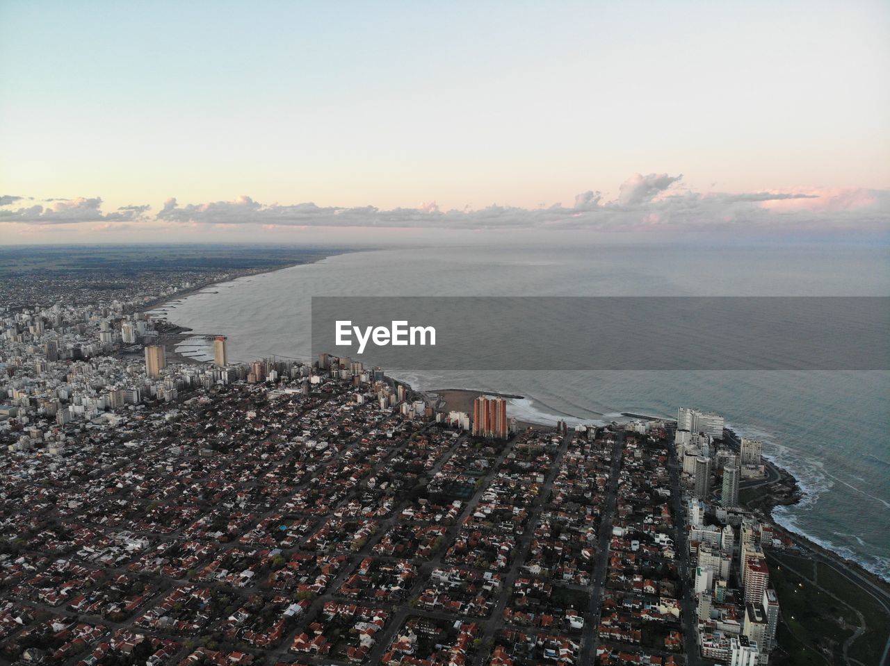 High angle view of buildings by sea against sky