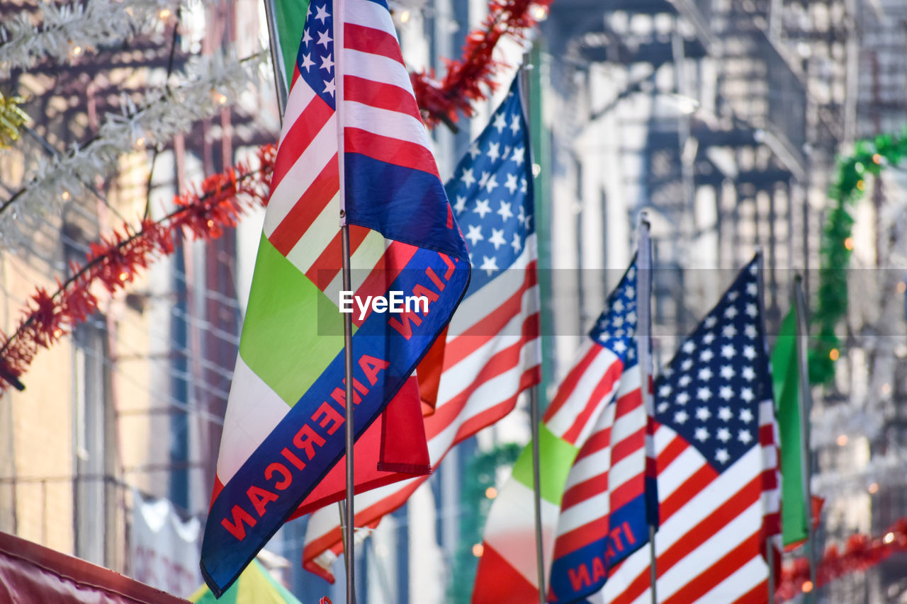 Italian and united states flags are seen at the feast of san gennaro, new york city.