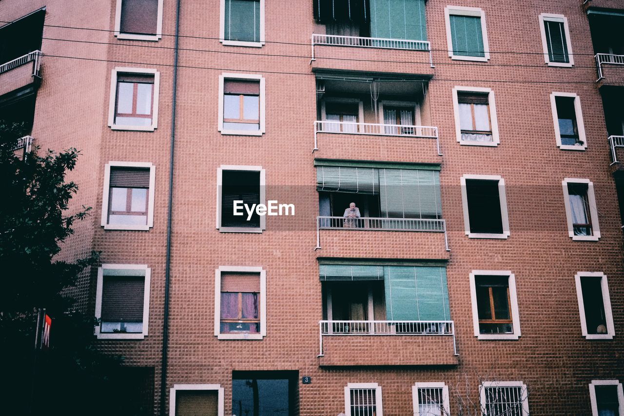 Low angle view of man standing in balcony