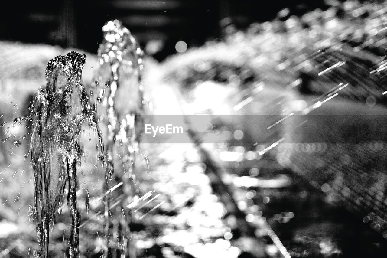 CLOSE-UP OF FROZEN WATER ON ILLUMINATED SURFACE