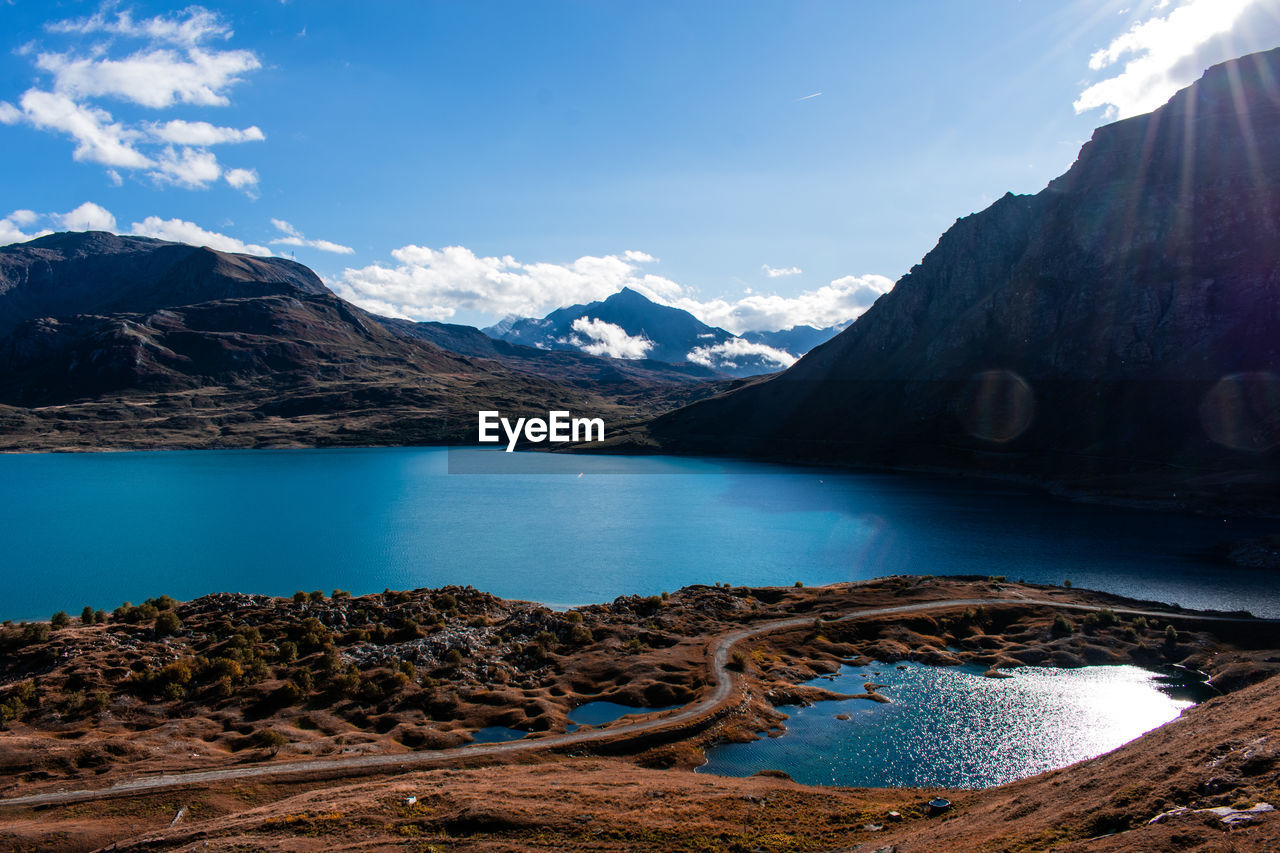 Scenic view of lake and mountains against sky