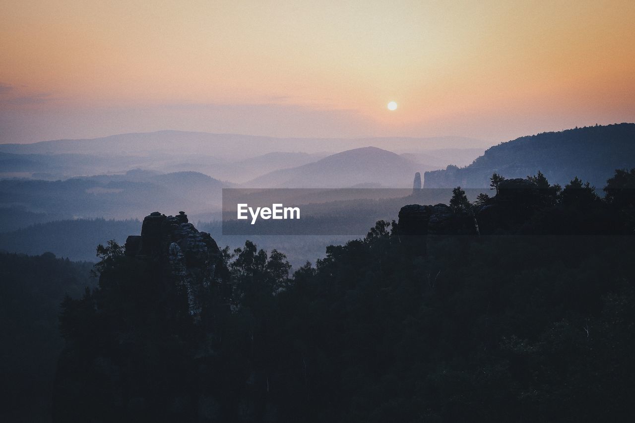 Scenic view of mountains against sky during sunrise