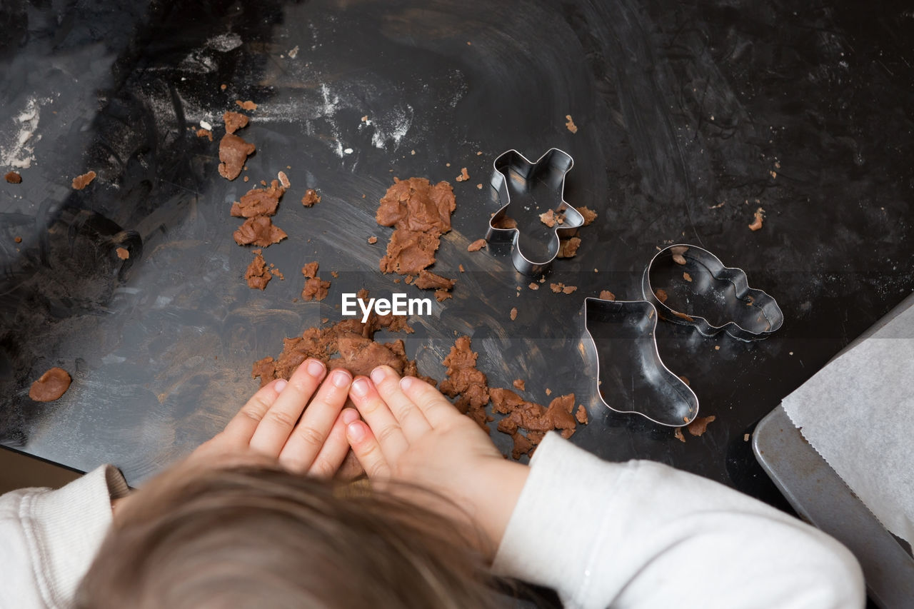 Cropped image of girl making gingerbread cookies