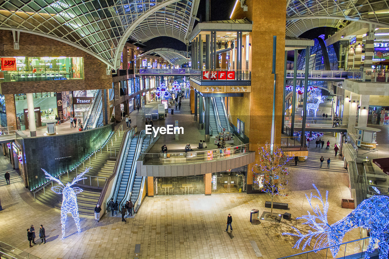 AERIAL VIEW OF ILLUMINATED SHOPPING MALL AT NIGHT