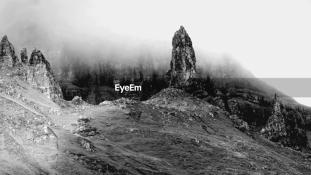 Scenic view of rocky mountains during foggy weather