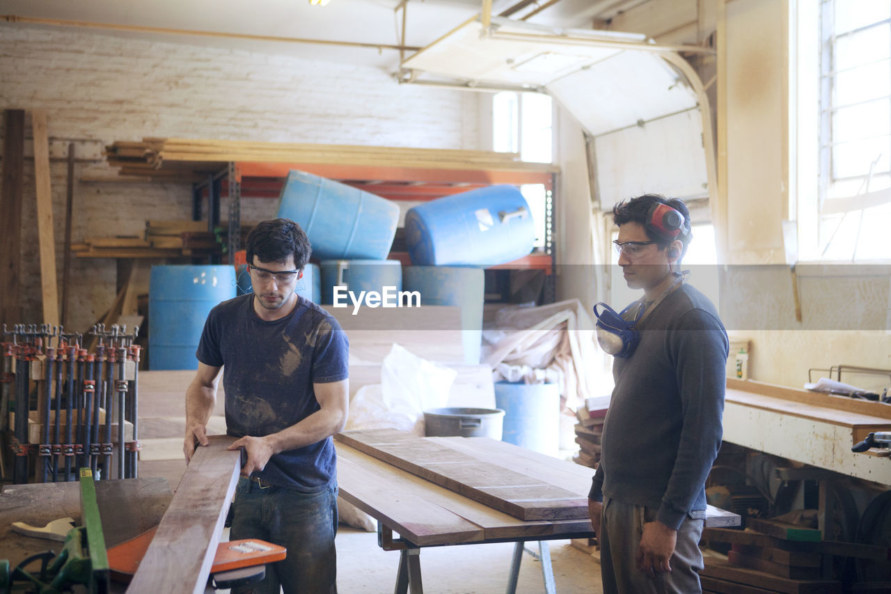 Male carpenters working in workshop