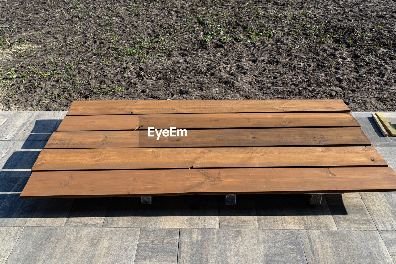 wood, high angle view, bench, no people, floor, day, nature, seat, hardwood, furniture, flooring, outdoors, brown, plant, sunlight, plank, table, footpath, empty, absence, pattern, walkway, park