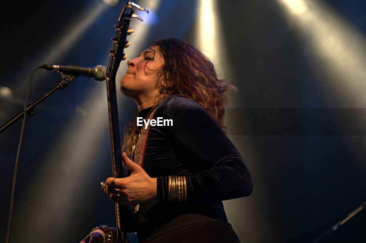 YOUNG WOMAN PLAYING WITH BALL IN MUSIC CONCERT