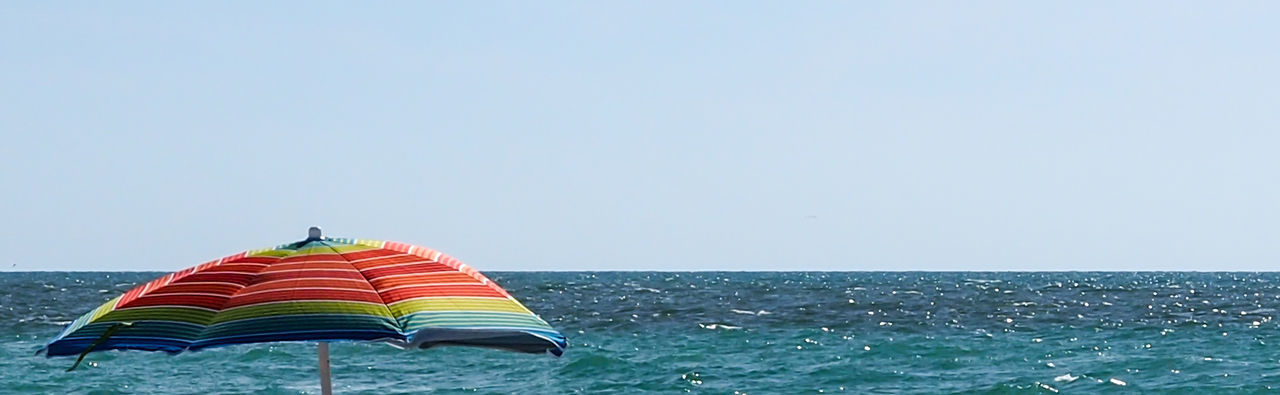 Umbrella against calm blue sea