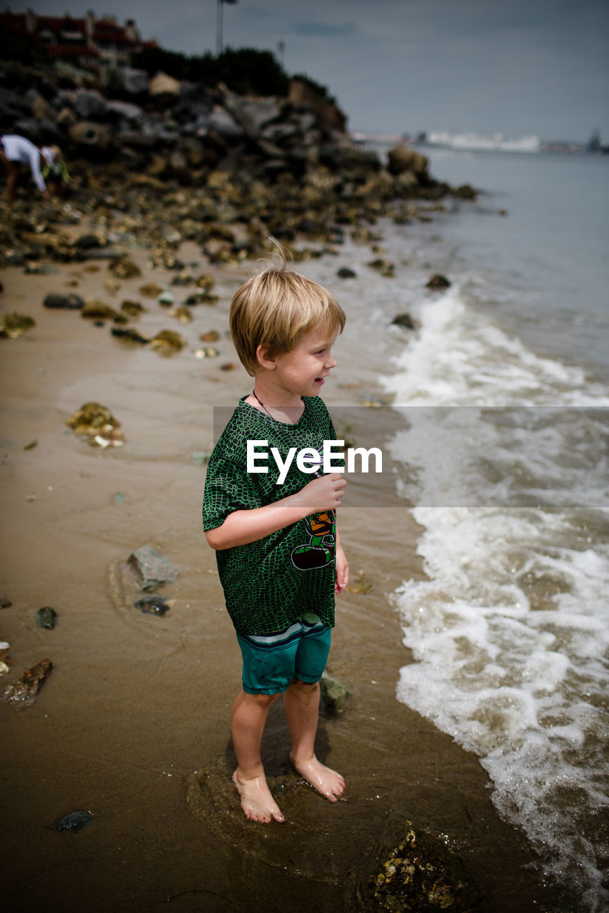 Six year old boy smiling & looking into coronado bay