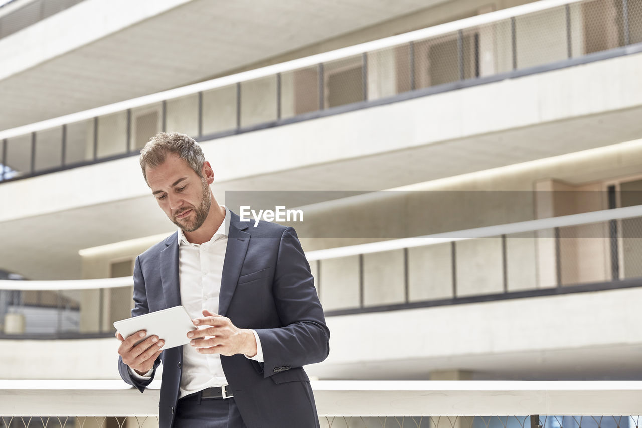 Businessman using tablet in office building