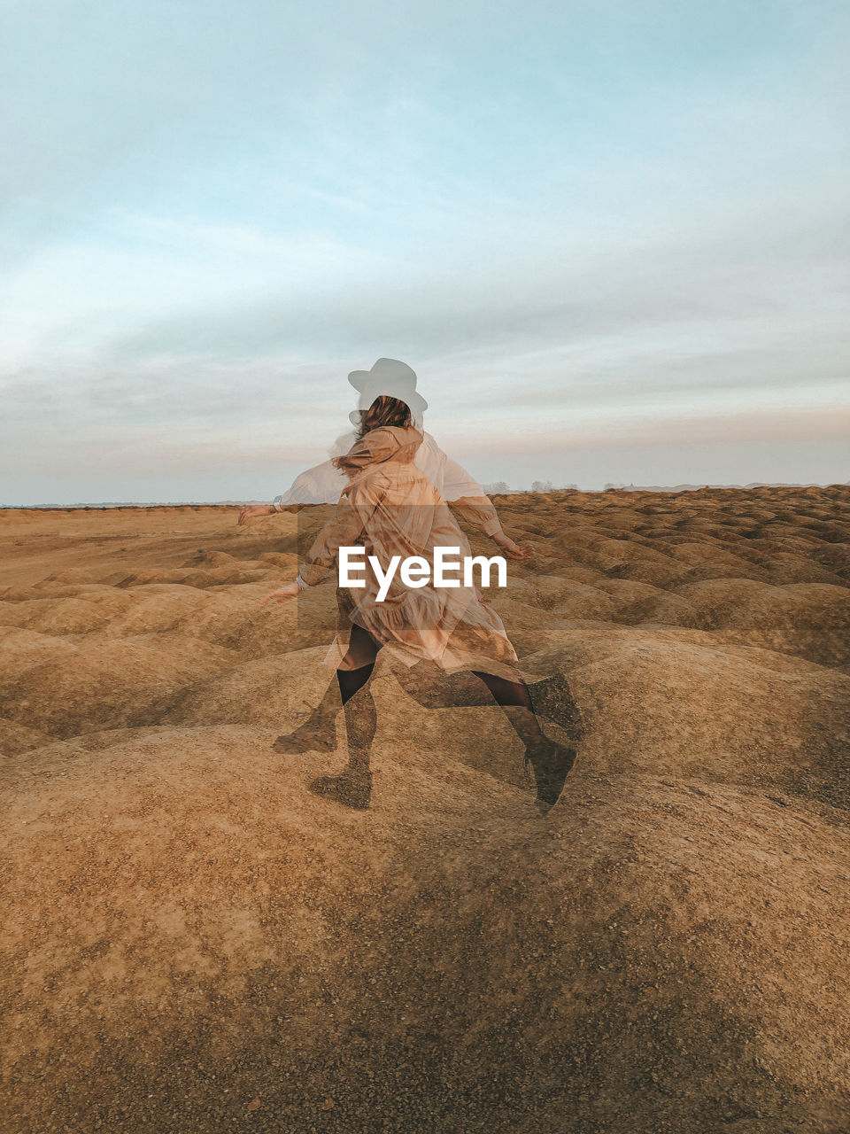 Multiple exposure image of young woman running on field