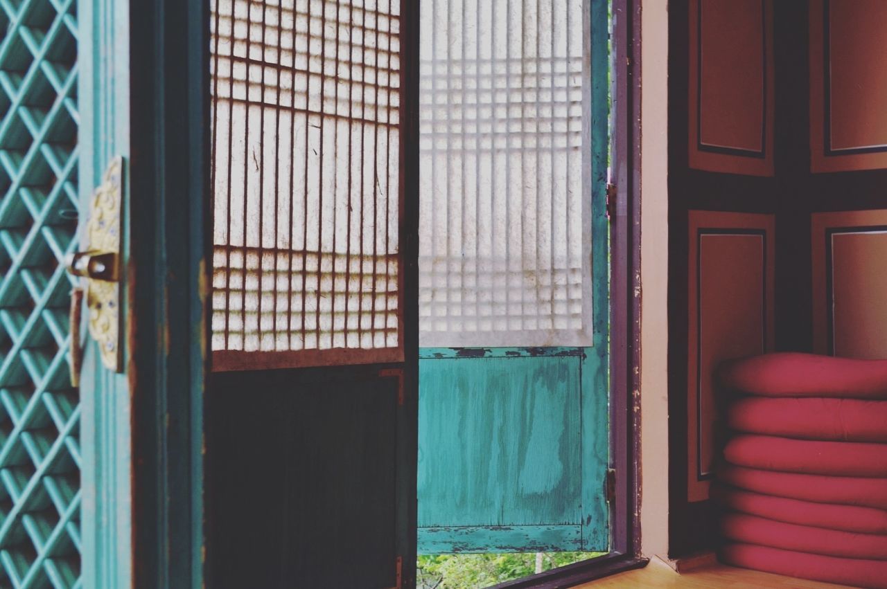 CLOSE-UP OF WINDOW IN MULTI COLORED CURTAIN