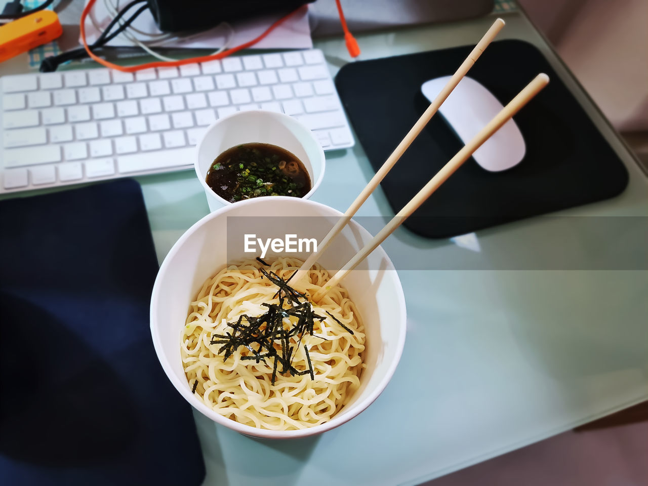 Instant cup noodles on messy table during work from home in quarantine periods