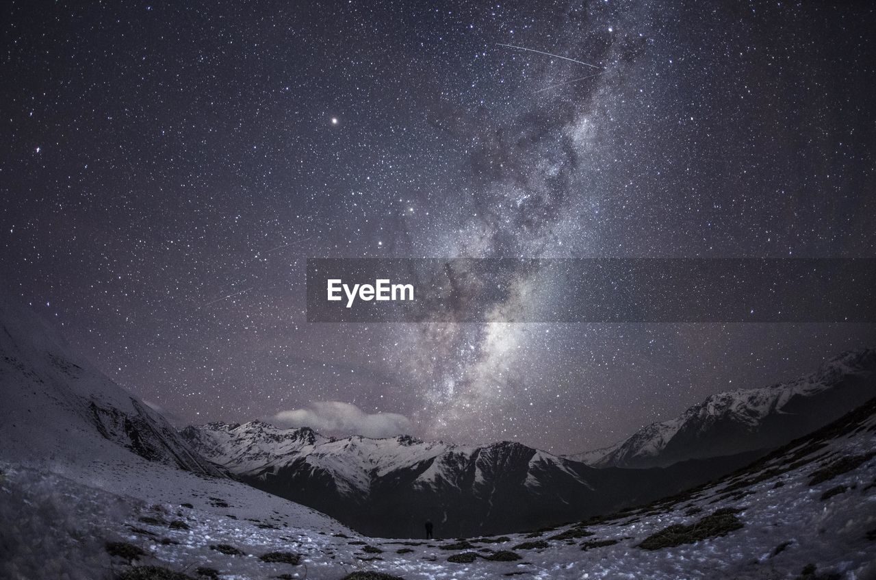 Scenic view of mountains against sky at night