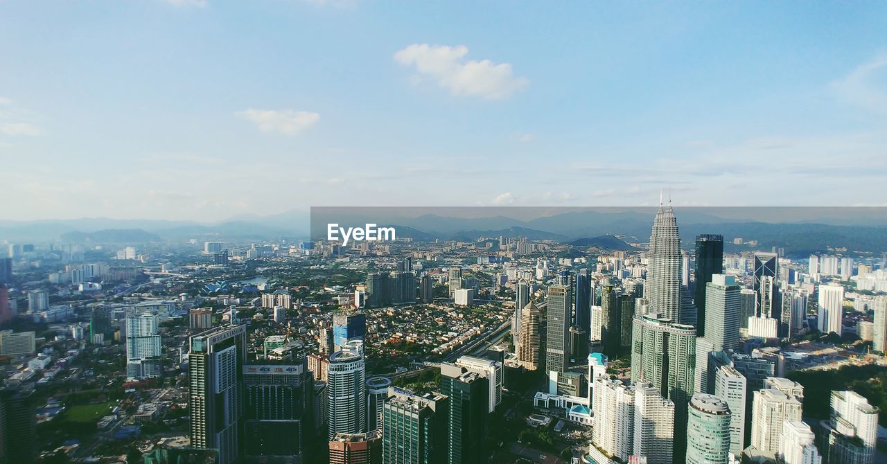 High angle view of modern buildings in city against sky