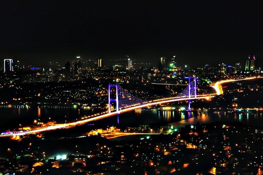 ILLUMINATED BRIDGE OVER RIVER